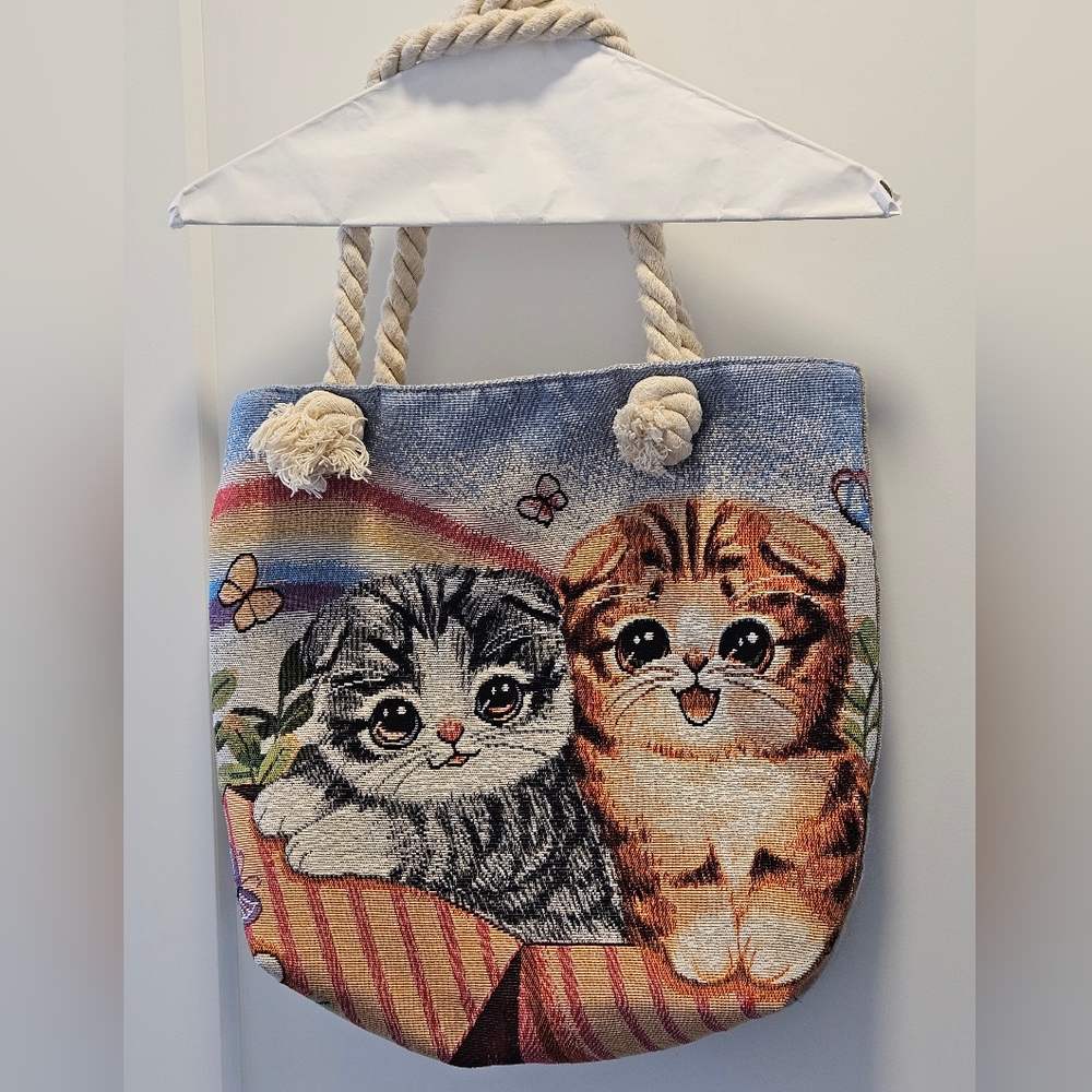 Tapestry-style shoulder bag features a woven design of two cute kittens